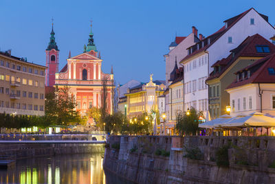 Buildings in city at dusk