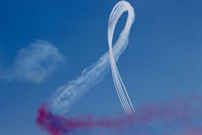 Low angle view of vapor trail against blue sky