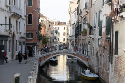 Bridge over canal amidst buildings in city