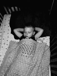 High angle view of young man laying on bed at home