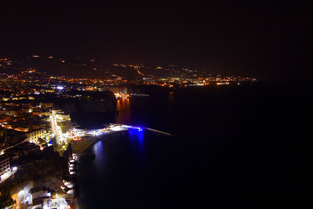 ILLUMINATED CITYSCAPE AGAINST SKY