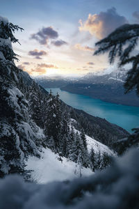 Scenic view of snow covered mountains against sky during sunset