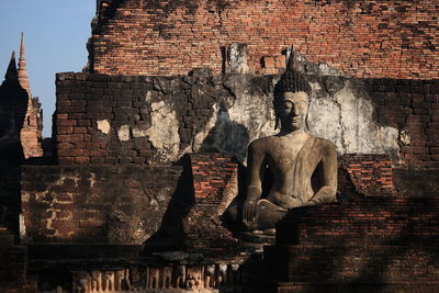Statue against temple
