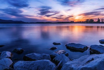 Scenic view of lake against sky during sunset