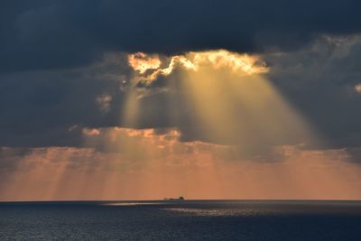 Scenic view of sea against storm clouds