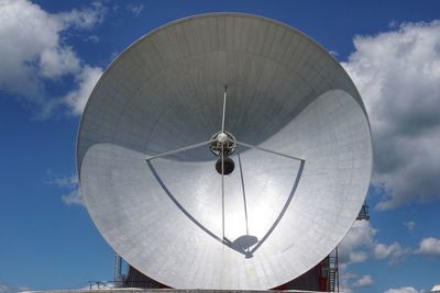 Low angle view of communications tower against sky