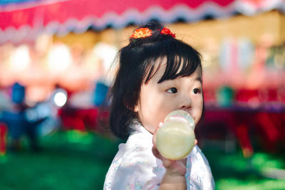 Close-up of boy blowing bubbles