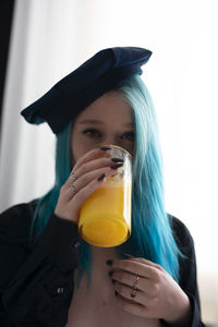 Portrait of a young woman drinking drink