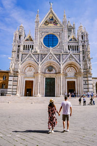 Group of people outside temple against building