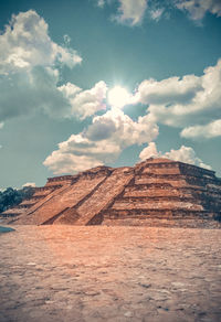 View of desert against cloudy sky