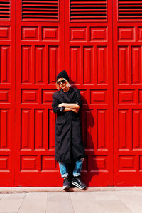 Stylish girl at the red door .urban fashion style