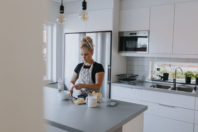 Young woman baking in kitchen