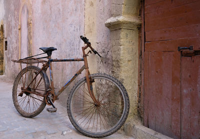 Bicycle leaning against wall