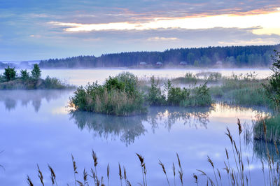 Scenic view of lake against sky during sunset