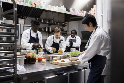 Multiracial chefs working in commercial kitchen at restaurant