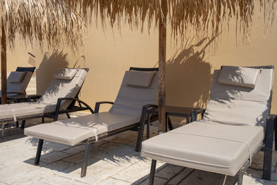 Empty chairs and tables on beach