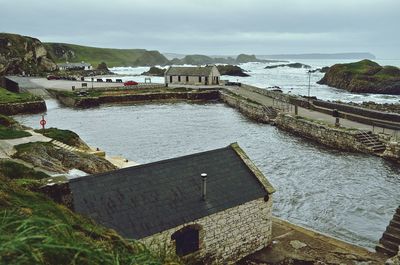 High angle view of houses and river against sky