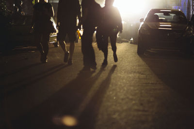 Group of people walking on road in city