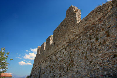 Low angle view of fort against blue sky