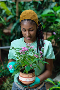 Portrait of smiling girl holding plant