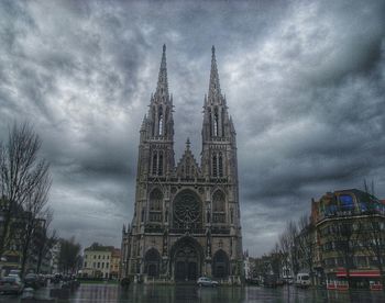 Buildings against cloudy sky