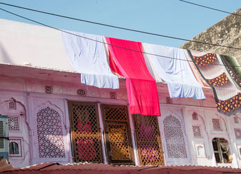 Low angle view of clothes drying against building