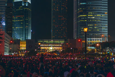 Crowd of people by illuminated building at night