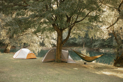 Hammock and tents by the river