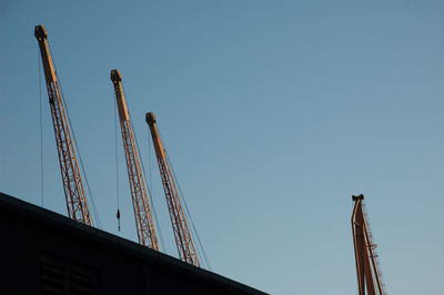 Low angle view of crane against clear sky