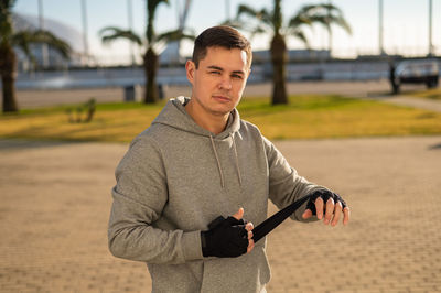 Portrait of young man standing in park