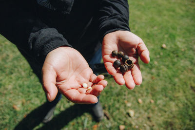 Midsection of man holding ice cream on field