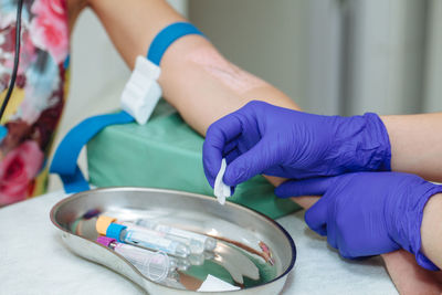 Cropped hands of doctor examining patient in hospital