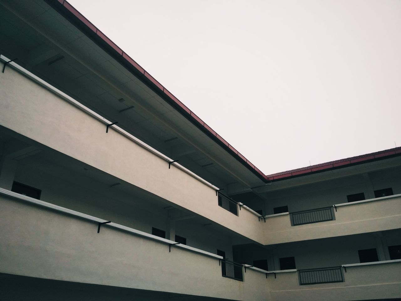 LOW ANGLE VIEW OF ROOF AGAINST CLEAR SKY IN CITY