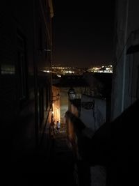 Silhouette people standing in illuminated city at night