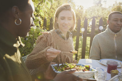 Friends having meal in garden