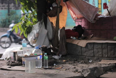 Close-up of plastic containers on footpath