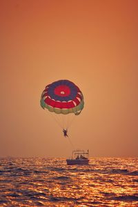 Ship in sea against sky during sunset