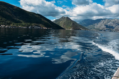 Scenic view of sea and mountains against sky