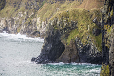 Scenic view of sea by rocks