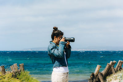 Woman photographing outdoors