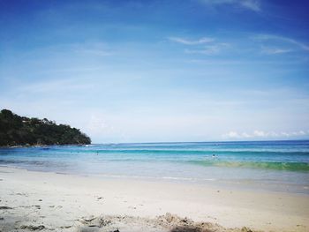 Scenic view of beach against blue sky