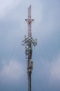 Low angle view of communications tower against sky