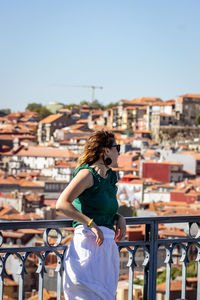 Rear view of woman looking at cityscape of porto