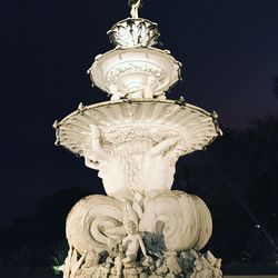 Low angle view of statue against sky at night