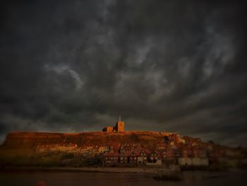 Buildings against cloudy sky