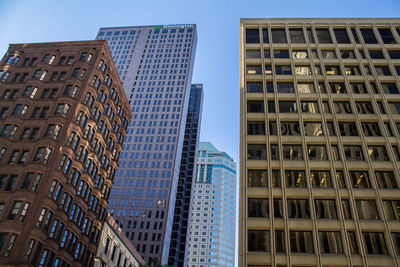 Low angle view of modern buildings against clear sky