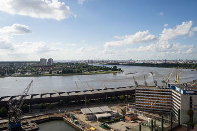 High angle view of cityscape by sea against sky