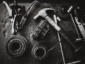 High angle view of hand tools and camera on table