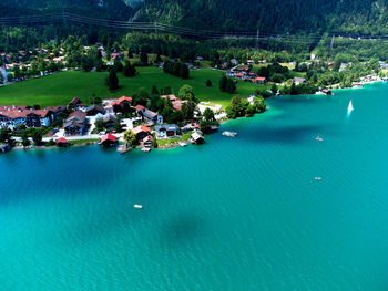 High angle view of swimming pool by sea against buildings