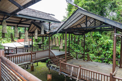 View of building and trees seen through railing